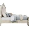Ornate Carved Panel Bed with Upholstered Headboard