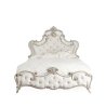 Luxurious Tufted Upholstered Bed with Ornate Carved Accents