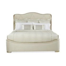 Elegant Upholstered Bed with Curved Headboard and Decorative Trim