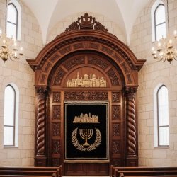 Premium handcrafted Aron Kodesh, masterfully carved wood synagogue furniture with gold velvet parochet.