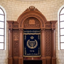 Exquisite Hand-Carved Aron Kodesh with Blue Velvet Parochet, a masterpiece of synagogue furniture by [Manufacturer Name].