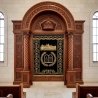 Elegant Aron Kodesh with hand-carved wood and embroidered velvet, a symbol of premium synagogue furniture manufacturing.