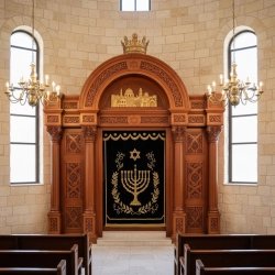 Exquisite hand-carved Aron Kodesh with embroidered velvet parochet, a testament to premium synagogue furniture manufacturing.