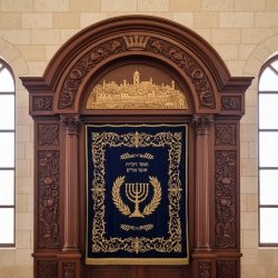 Finely crafted Aron Kodesh, showcasing intricate wood carving and sacred design, ideal for synagogue interiors.