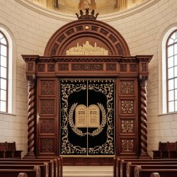 Hand-carved solid wood Aron Kodesh with deep blue velvet curtain, premium synagogue furniture for sacred spaces.