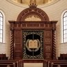 Hand-carved solid wood Aron Kodesh with deep blue velvet curtain, premium synagogue furniture for sacred spaces.