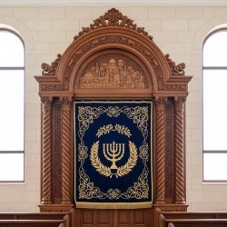 Magnificent Handcrafted Aron Kodesh: Dark Hardwood Holy Ark with Jerusalem Embroidery & Symbolic Carvings for Synagogue.