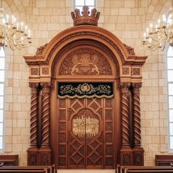 Exquisitely manufactured Aron Kodesh, featuring premium wood and ornate embroidery, perfect for synagogue sanctuaries.