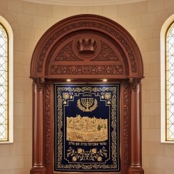 Finely crafted Aron Kodesh with ornate wood and embroidered velvet, reflecting superior manufacturing for synagogues.