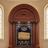 Finely crafted Aron Kodesh with ornate wood and embroidered velvet, reflecting superior manufacturing for synagogues.