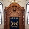 Exquisite Aron Kodesh: Handcrafted wood, intricate carvings, and luxurious blue velvet parochet.