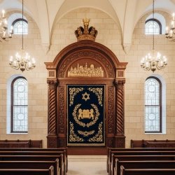 Premium handcrafted Aron Kodesh: Solid wood, deep blue velvet, golden embroidery, bespoke synagogue furniture.