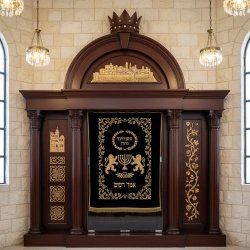 Majestic Aron Kodesh: Hand-carved wood and deep blue velvet, a testament to exquisite furniture craftsmanship for sacred spaces.