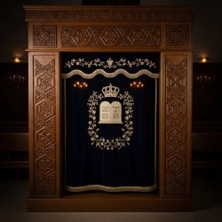 A realistic image of Mahogany Wood Aron Kodesh, Torah Ark hand carvings, image generated by Gemini-2.5-Flash.
