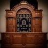 A realistic image of Mahogany Wood Aron Kodesh, Torah Ark hand carvings, image generated by Gemini-2.5-Flash.