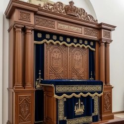 A realistic image of Mahogany Wood Aron Kodesh, Torah Ark hand carvings, image generated by Gemini-2.5-Flash.