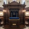 A realistic image of Mahogany Wood Aron Kodesh, Torah Ark hand carvings, image generated by Gemini-2.5-Flash.